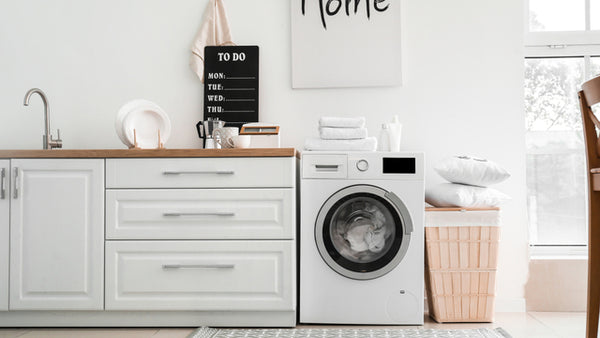 washing machine in stylish white kitchen